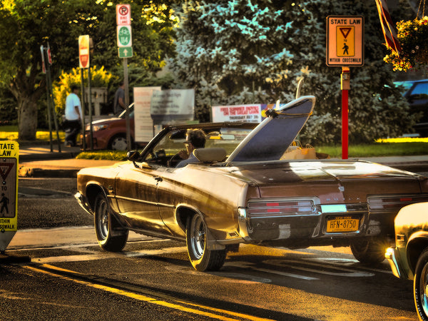 Man in Convertible with Surfboard